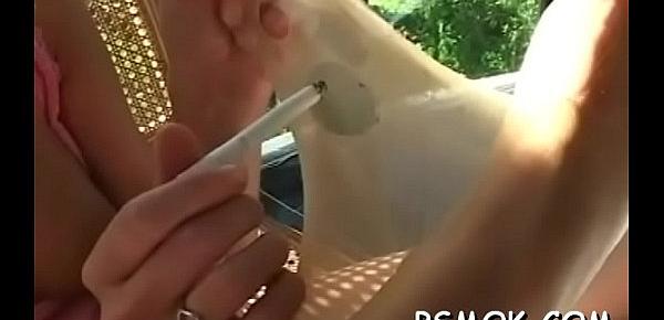  Concupiscent bitch shows pussy and relaxes herself with a cigarette